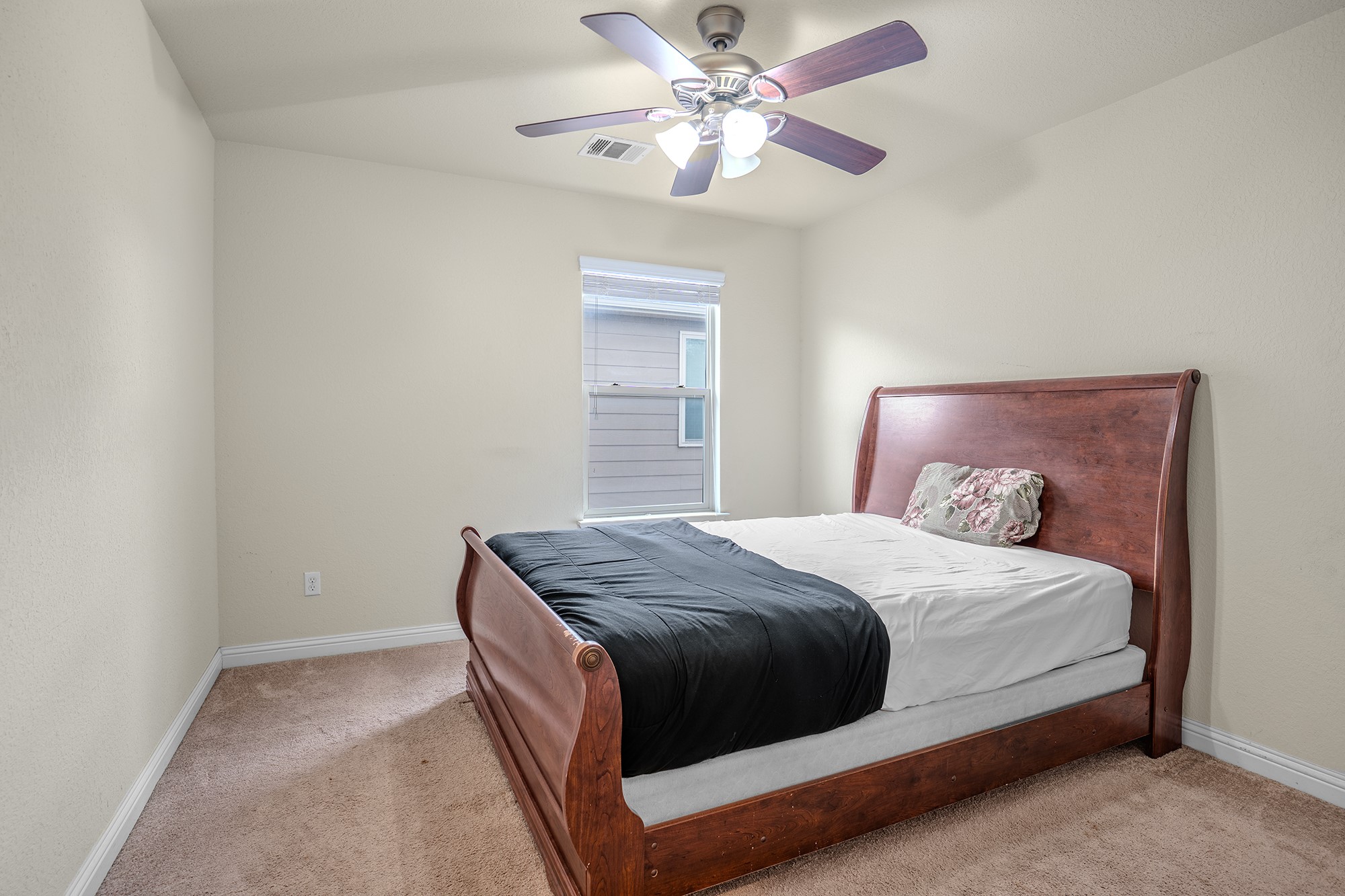 16012 McAloon Way Austin, TX 78728 - Photo 30 of 34 a bedroom with a bed and a chandelier