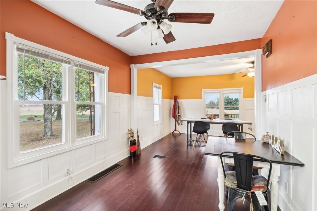 22120 Center Road Alliance, OH 44601 - Photo 22 of 41 Office space with a decorative wall, a ceiling fan, wainscoting, and dark wood-type flooring
