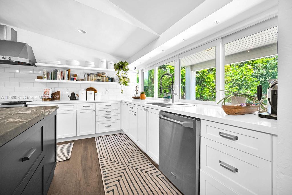 7761 Southwest 170th Street Palmetto Bay, FL 33157 - Photo 13 of 39 a kitchen with a sink stove and cabinets