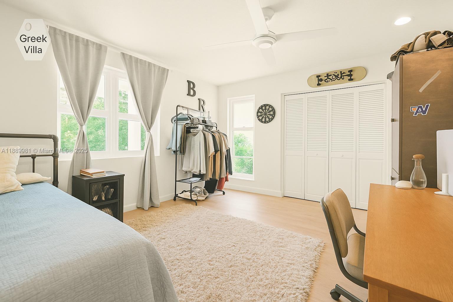 7761 Southwest 170th Street Palmetto Bay, FL 33157 - Photo 16 of 39 a bedroom with a bed a table and a large window