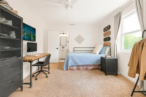 a bedroom with furniture and a window