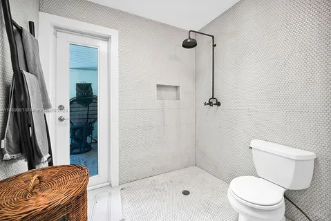 a bathroom with a toilet and a shower