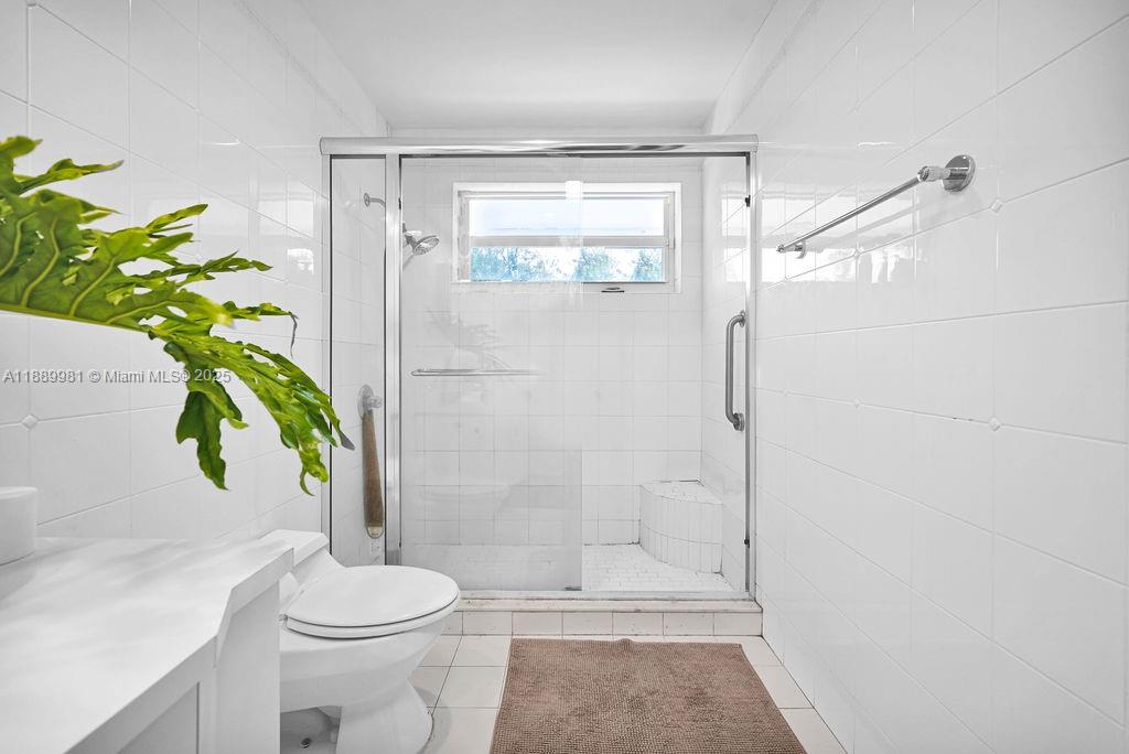 7761 Southwest 170th Street Palmetto Bay, FL 33157 - Photo 25 of 39 a bathroom with a toilet and shower