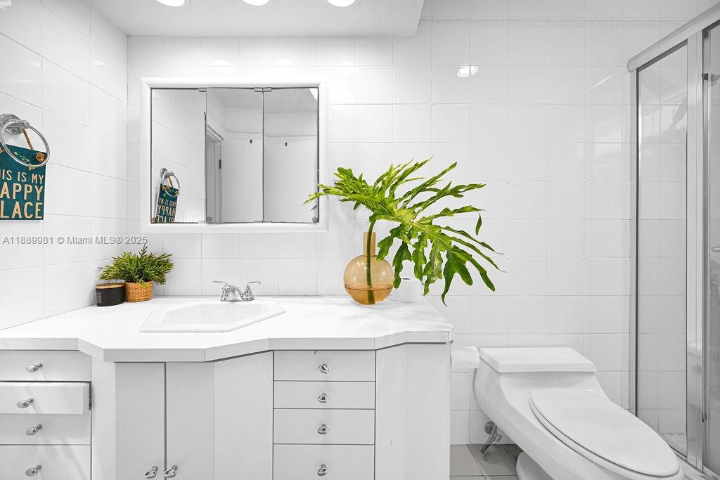 7761 Southwest 170th Street Palmetto Bay, FL 33157 - Photo 27 of 39 a bathroom with a sink a toilet and a mirror