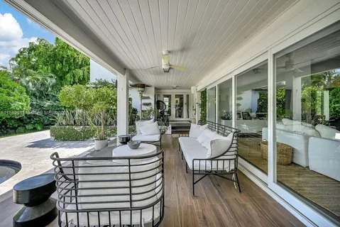 a view of a patio with a dining table and chairs