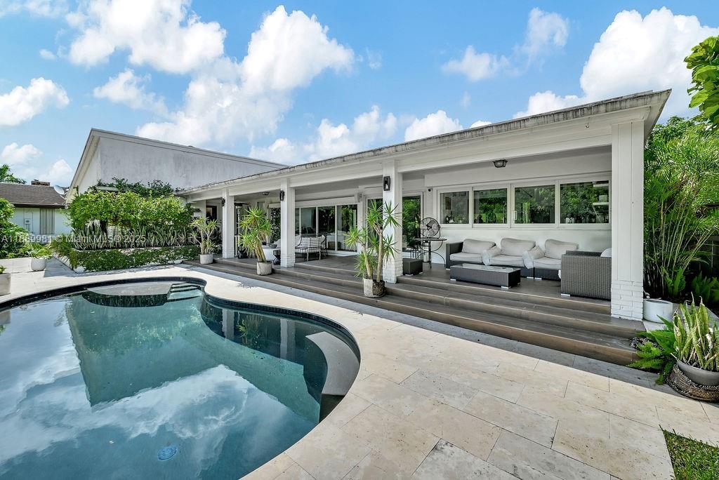 7761 Southwest 170th Street Palmetto Bay, FL 33157 - Photo 34 of 39 a view of a patio with couches and pool table and chairs