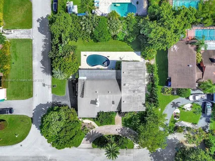 an aerial view of a house with outdoor space and street view