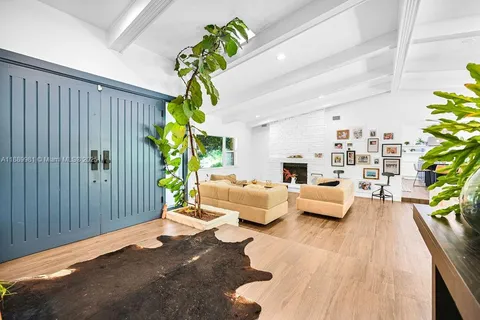 a living room with furniture and a potted plant