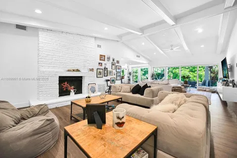 a living room with furniture potted plant and a fireplace