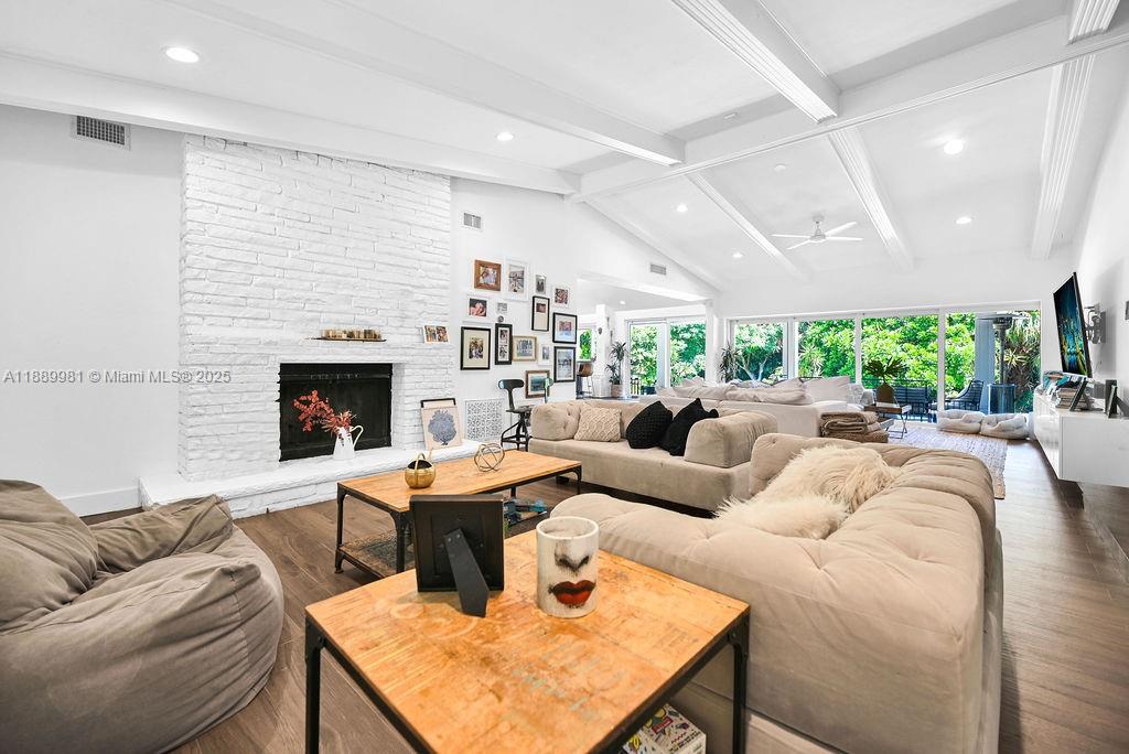 7761 Southwest 170th Street Palmetto Bay, FL 33157 - Photo 10 of 39 a living room with furniture potted plant and a fireplace