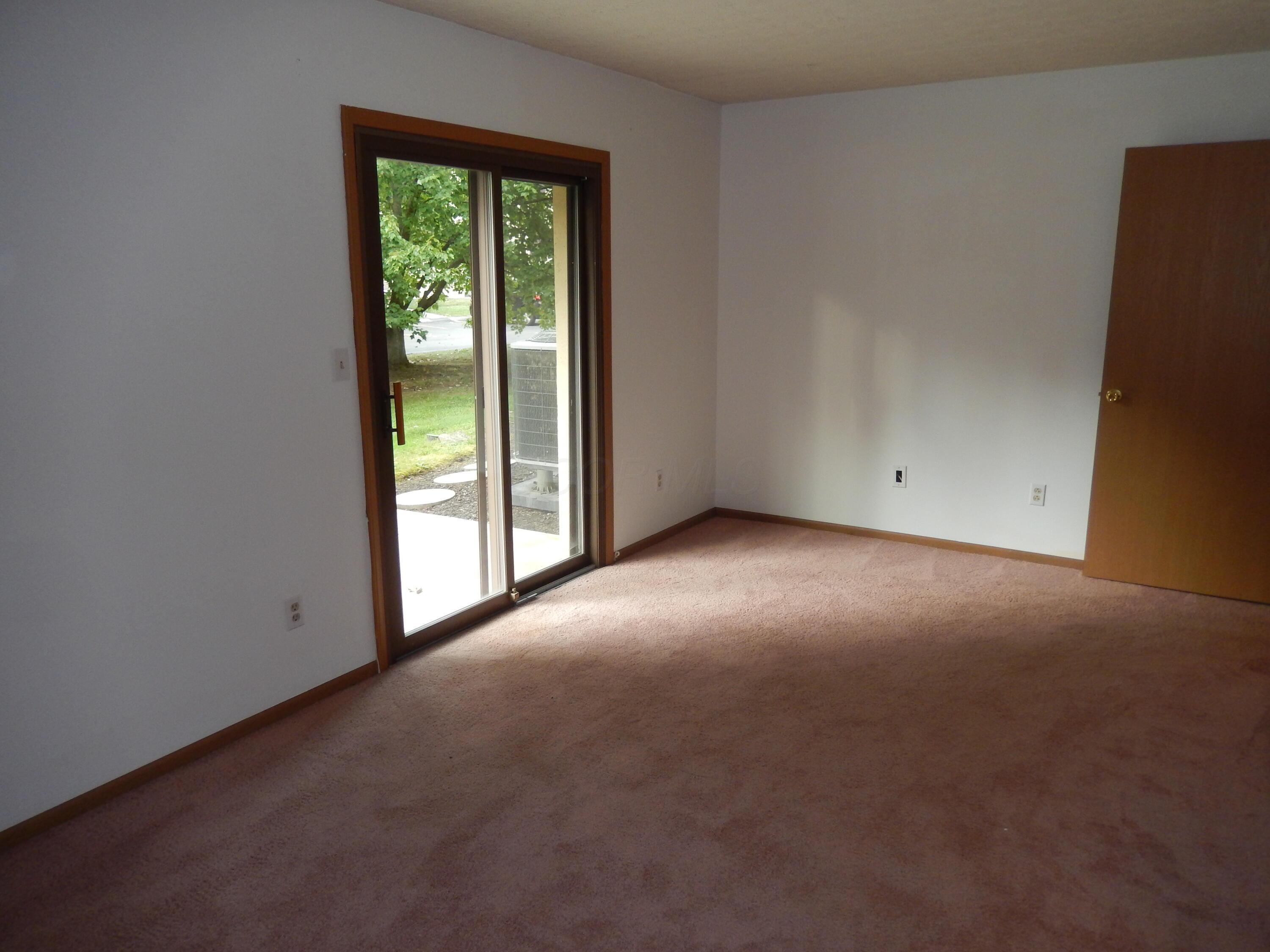 3939 Karl Road, Unit 122 Columbus, OH 43224 - Photo 30 of 57 Primary Bedroom with sliding door to covered patio