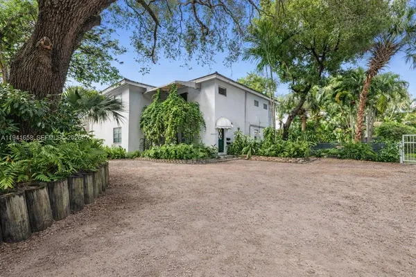 a view of a house with a plants and trees