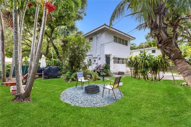 a view of a house with a yard patio and swimming pool