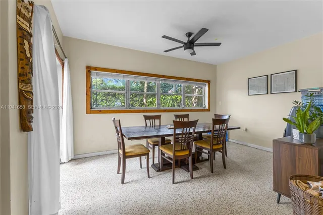a view of a dining room with furniture and a window
