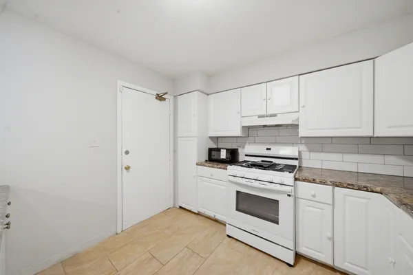 a kitchen with cabinets appliances and a sink