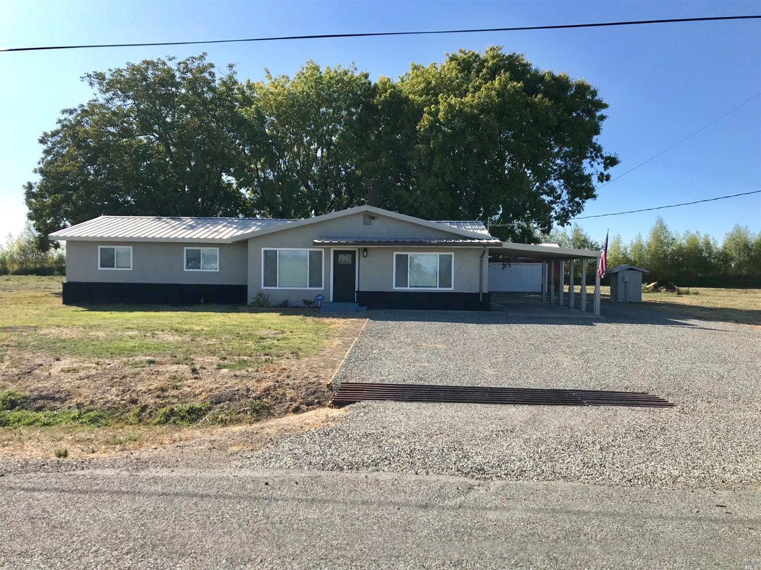 1763 Riley Road Gridley, CA 95948 - Photo 1 of 1 a house with trees in the background
