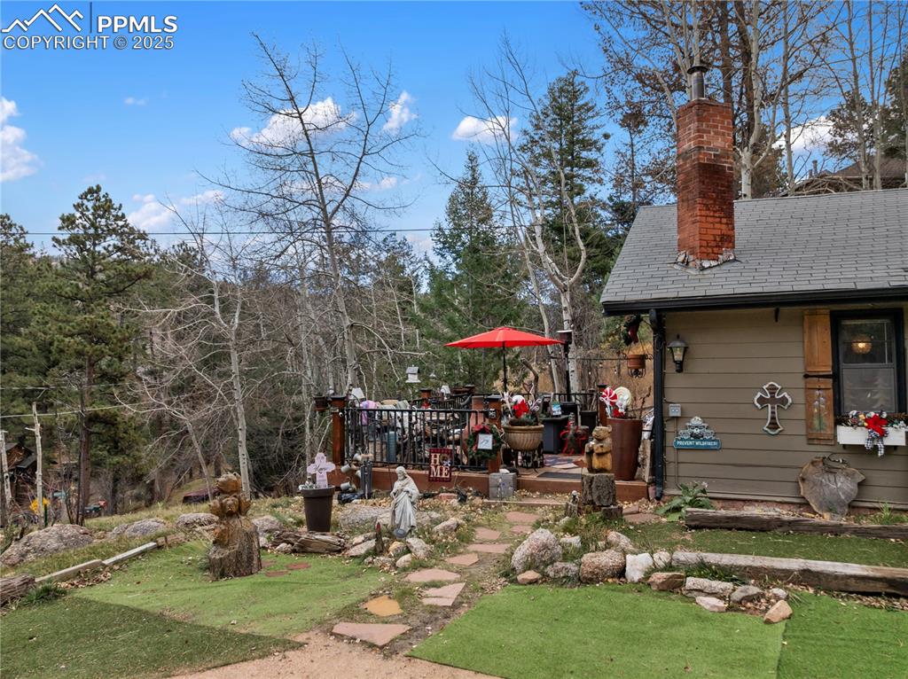 10155 Mountain Road Cascade, CO 80809 - Photo 12 of 47 a front view of a house with garden