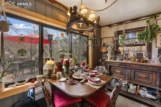 a view of a dining room with furniture wooden floor and a chandelier