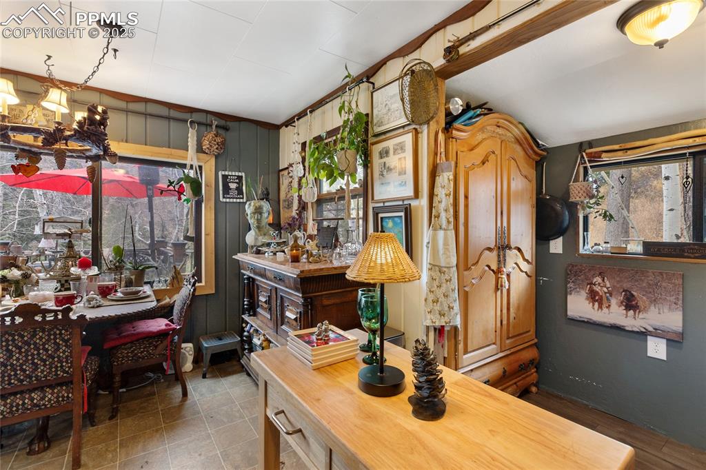 10155 Mountain Road Cascade, CO 80809 - Photo 23 of 47 a view of a dining room with furniture and chandelier