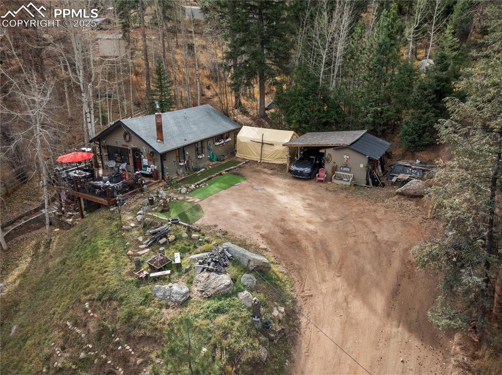 10155 Mountain Road Cascade, CO 80809 - Photo 44 of 47 an aerial view of a house with a yard and large trees
