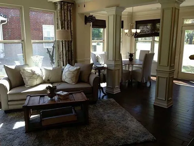 a living room with furniture wooden floor and a table