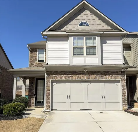 a front view of a house with a garage