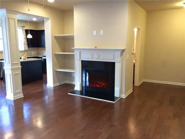 a living room with wooden floors and a fireplace