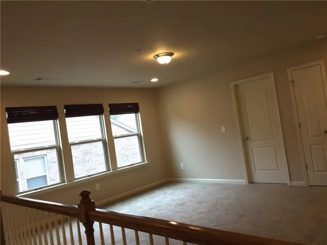 an empty room with large windows