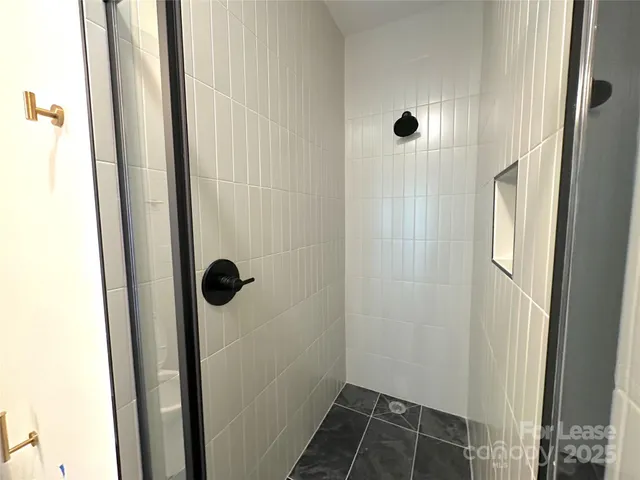 a bathroom with a glass shower door