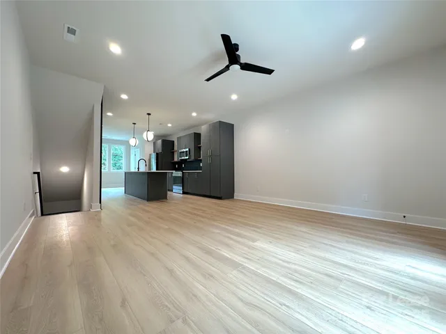 a view of a kitchen with a sink and a large window
