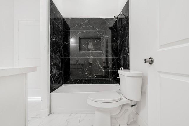 5306 Ridgeway Drive, Unit A Houston, TX 77033 - Photo 7 of 7 Designer bathroom featuring a modern vanity, sleek finishes, and a statement tile surround for a polished, contemporary aesthetic.