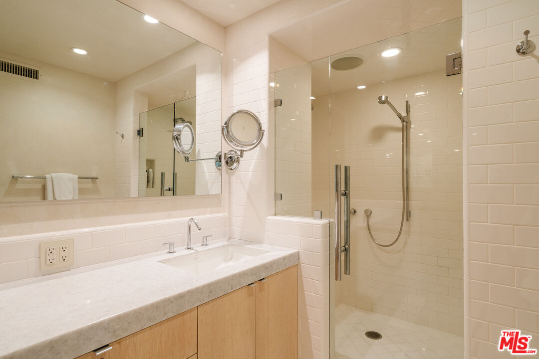 9255 Doheny Road, Unit 2603 West Hollywood, CA 90069 - Photo 12 of 17 a bathroom with a sink and a mirror