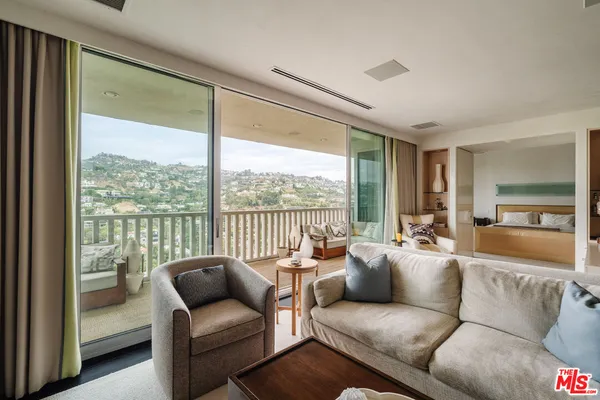 a living room with furniture and a floor to ceiling window