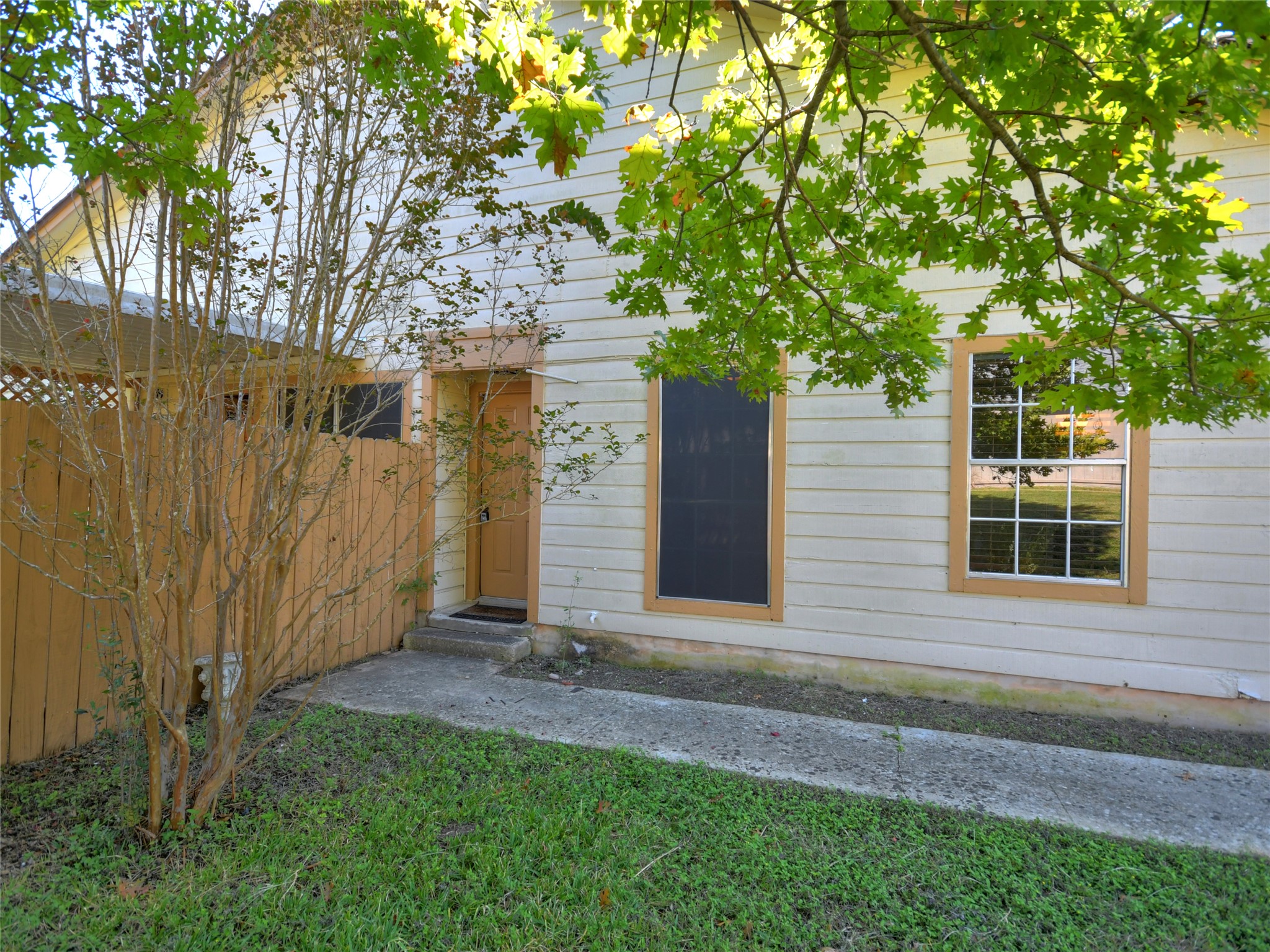 415 Fantail Loop, Unit A Austin, TX 78734 - Photo 2 of 15 Exterior siding with white horizontal panels and contrasting tan window trim