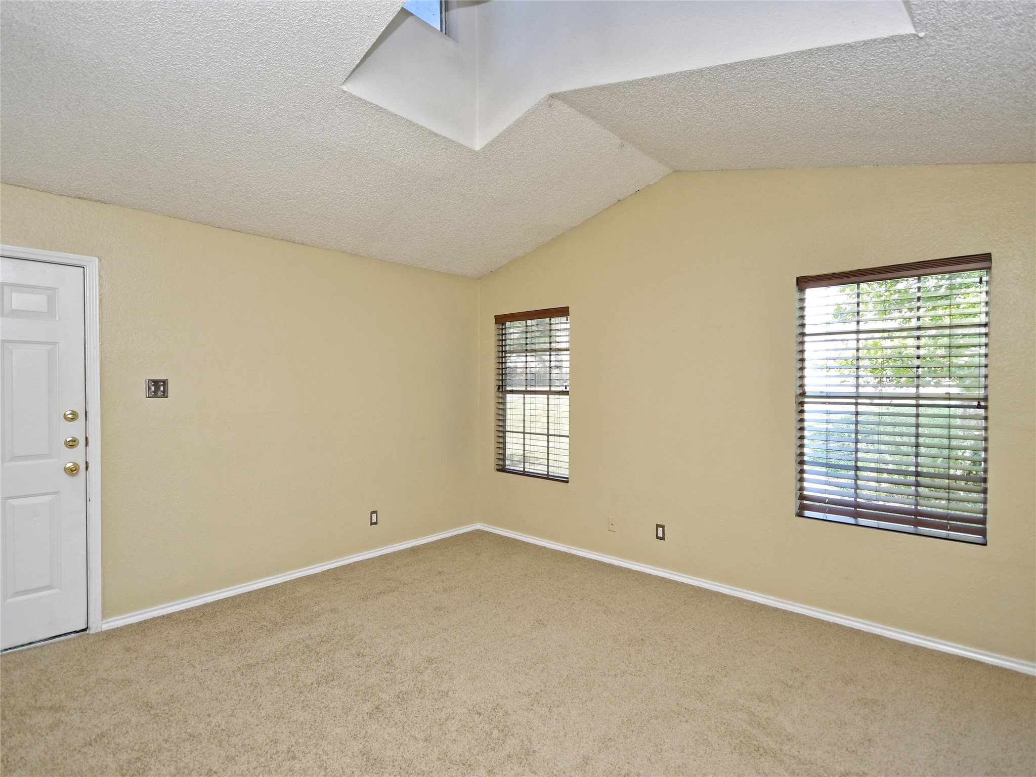 415 Fantail Loop, Unit A Austin, TX 78734 - Photo 9 of 15 Room featuring a vaulted ceiling and skylight