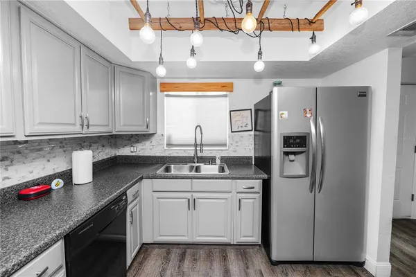 a kitchen with stainless steel appliances granite countertop a sink and cabinets