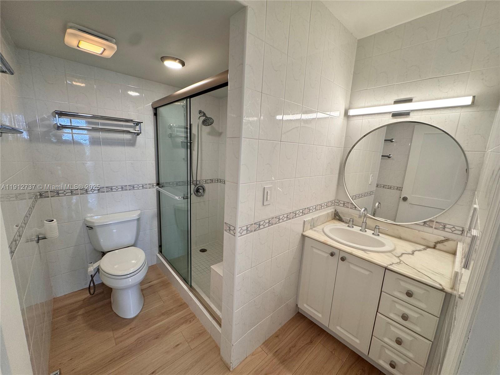 2899 Collins Avenue, Unit 1212 Miami Beach, FL 33140 - Photo 12 of 37 a bathroom with a toilet sink and mirror