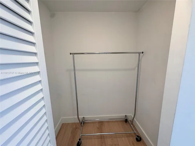 a view of a hallway with two chairs