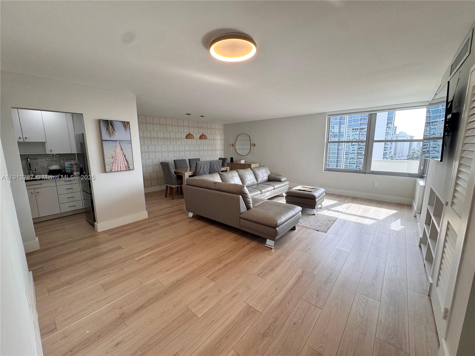 2899 Collins Avenue, Unit 1212 Miami Beach, FL 33140 - Photo 2 of 37 a living room with furniture and a large window