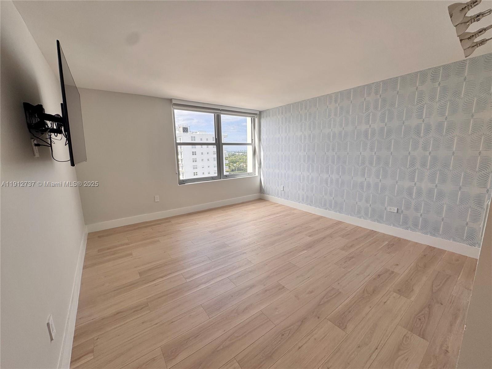 2899 Collins Avenue, Unit 1212 Miami Beach, FL 33140 - Photo 10 of 37 an empty room with windows