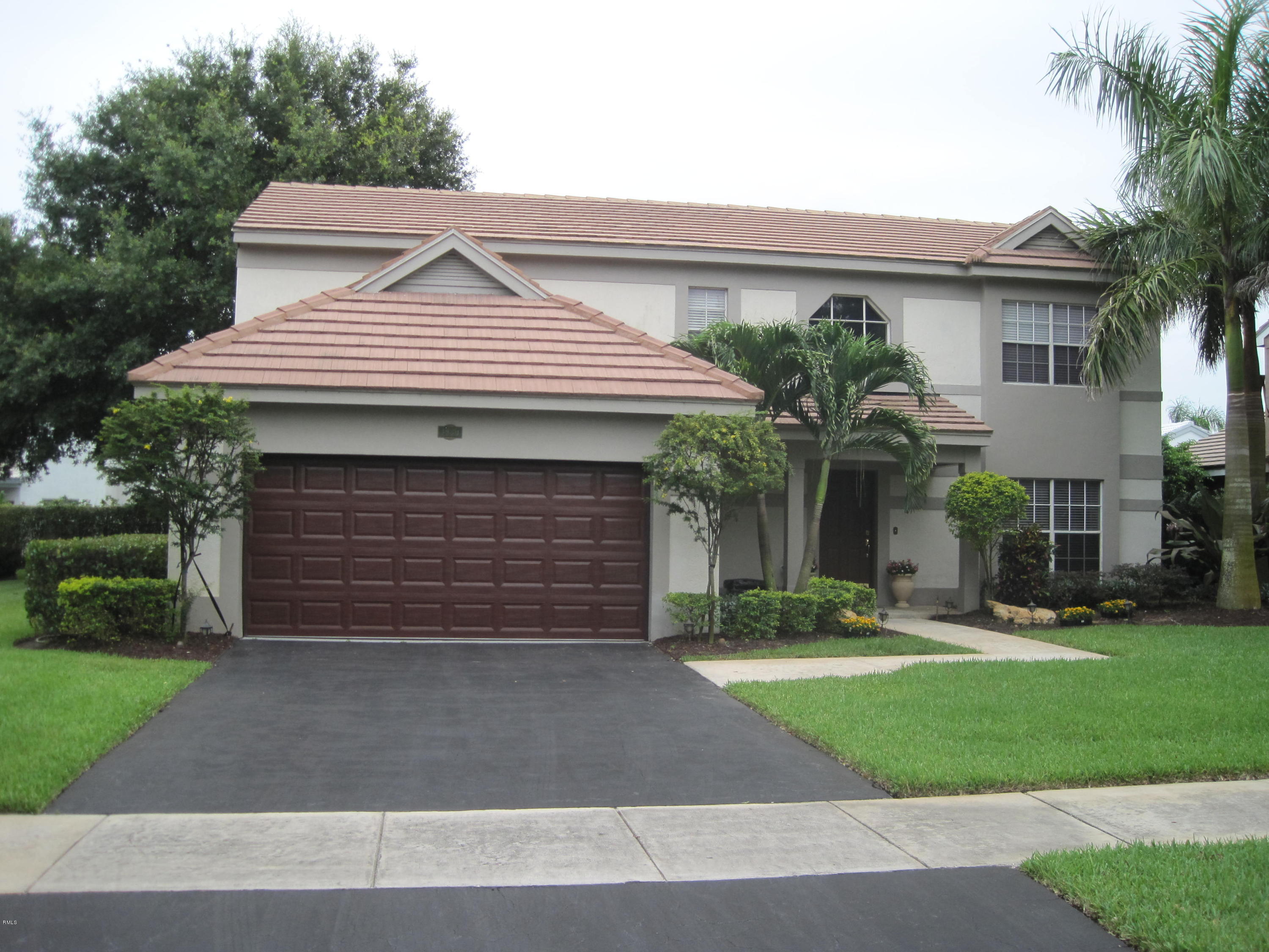 3930 Sabal Lakes Road Delray Beach, FL 33445 - Photo 1 of 30 a front view of a house with a yard and garage