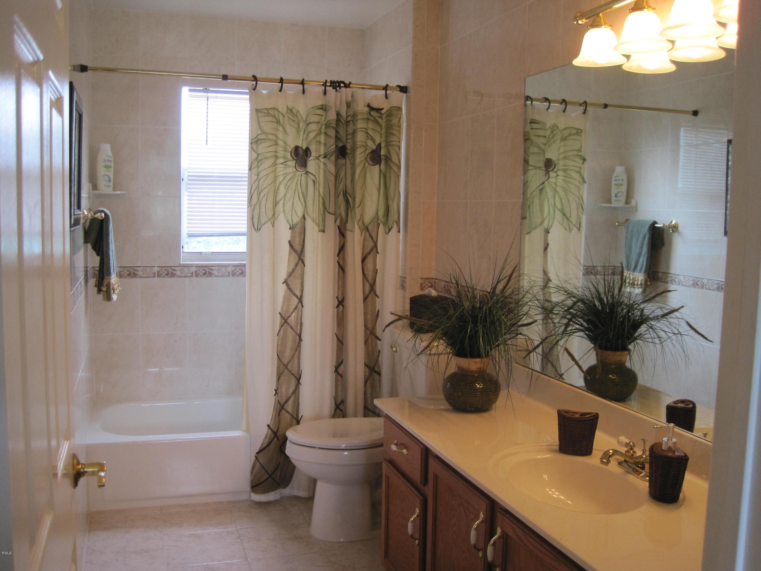 3930 Sabal Lakes Road Delray Beach, FL 33445 - Photo 11 of 30 a bathroom with a sink a toilet and a tub
