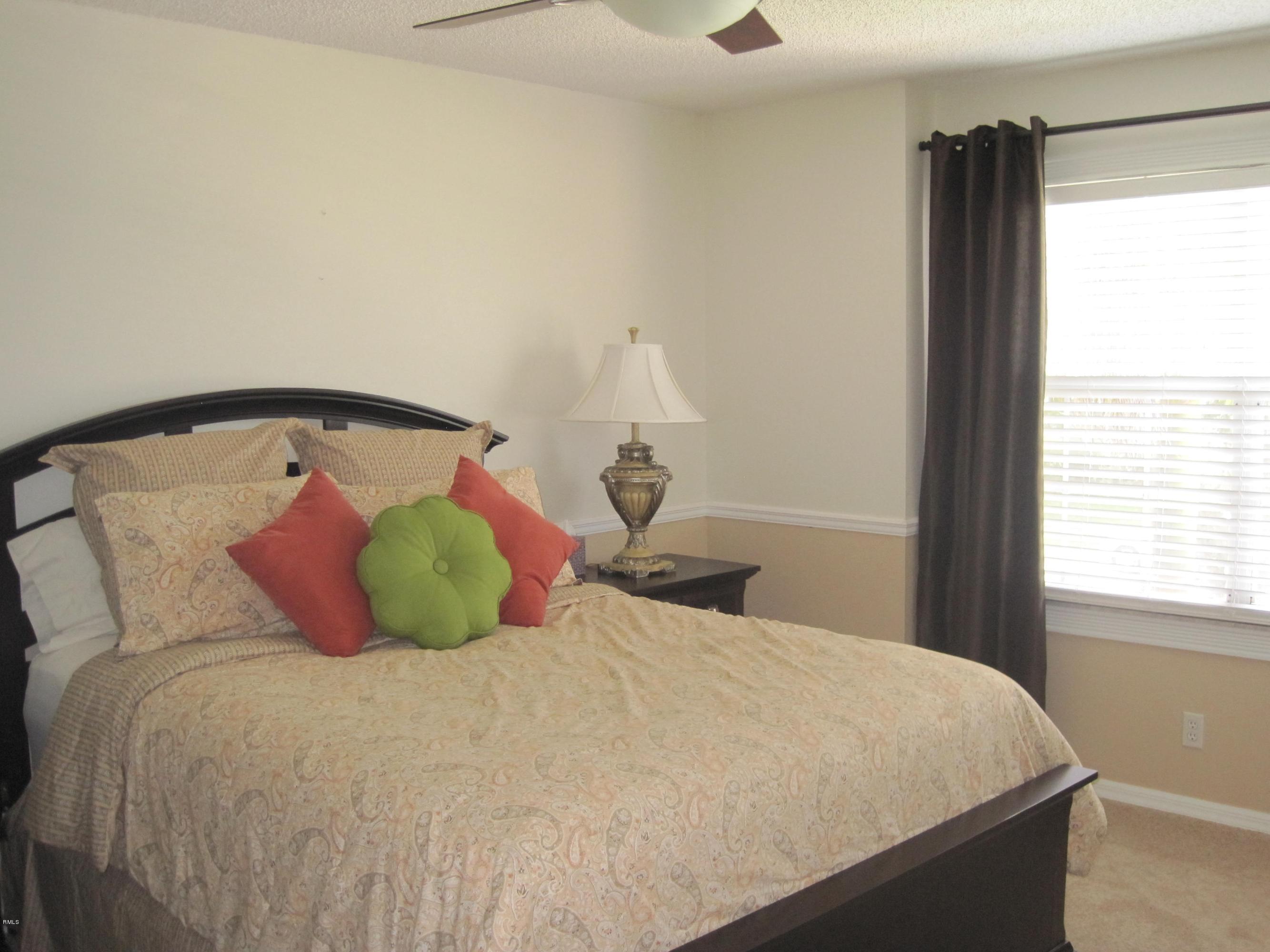 3930 Sabal Lakes Road Delray Beach, FL 33445 - Photo 13 of 30 a bedroom with a large bed and a window