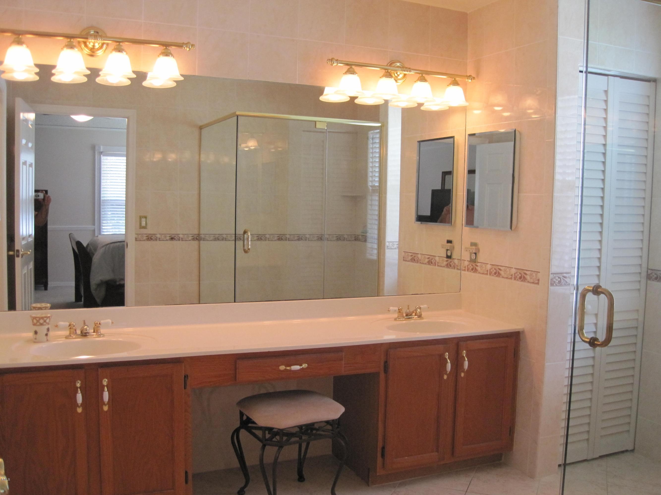 3930 Sabal Lakes Road Delray Beach, FL 33445 - Photo 16 of 30 a bathroom with a sink double vanity and a shower