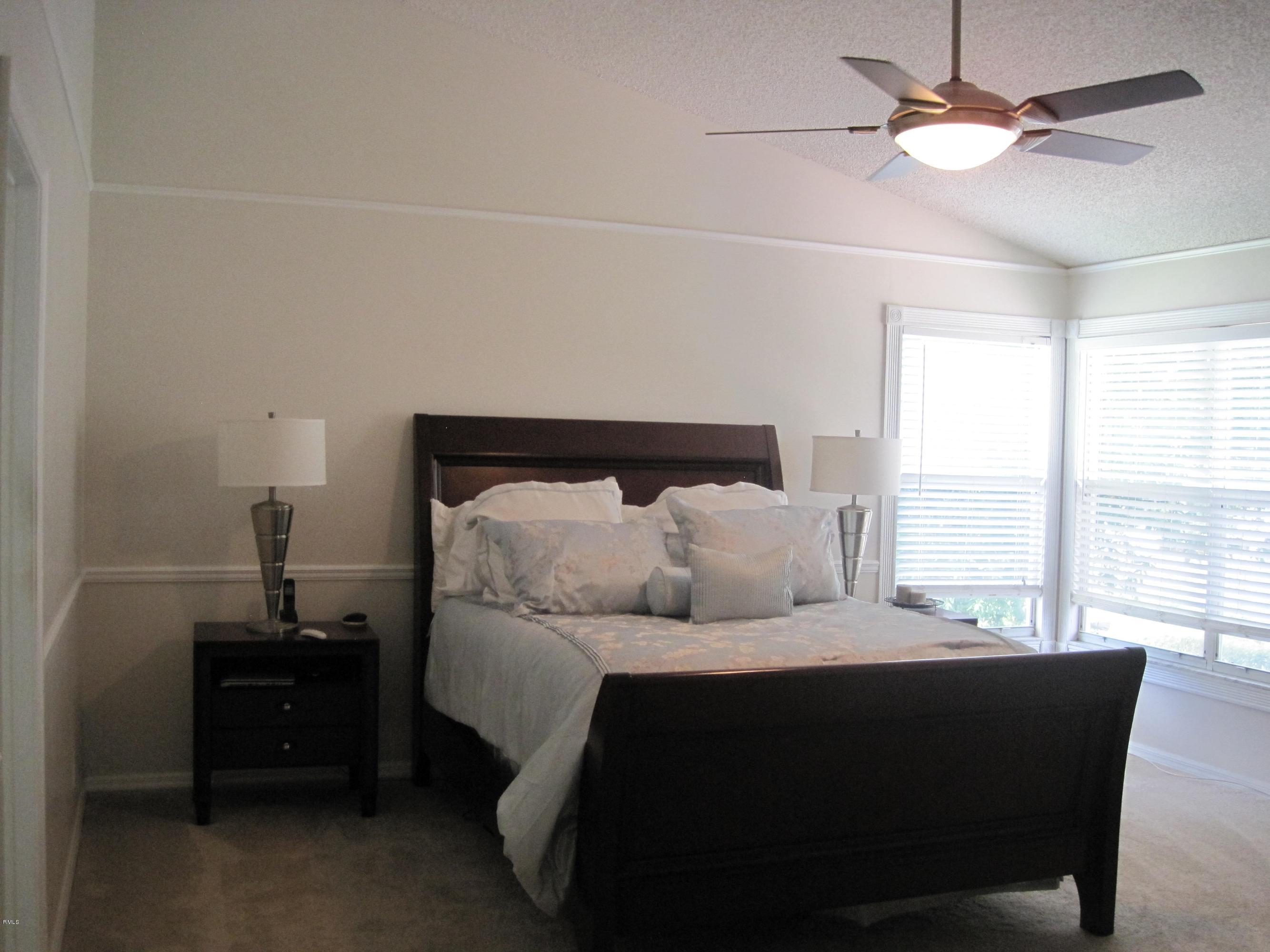 3930 Sabal Lakes Road Delray Beach, FL 33445 - Photo 18 of 30 a bedroom with a bed and a window
