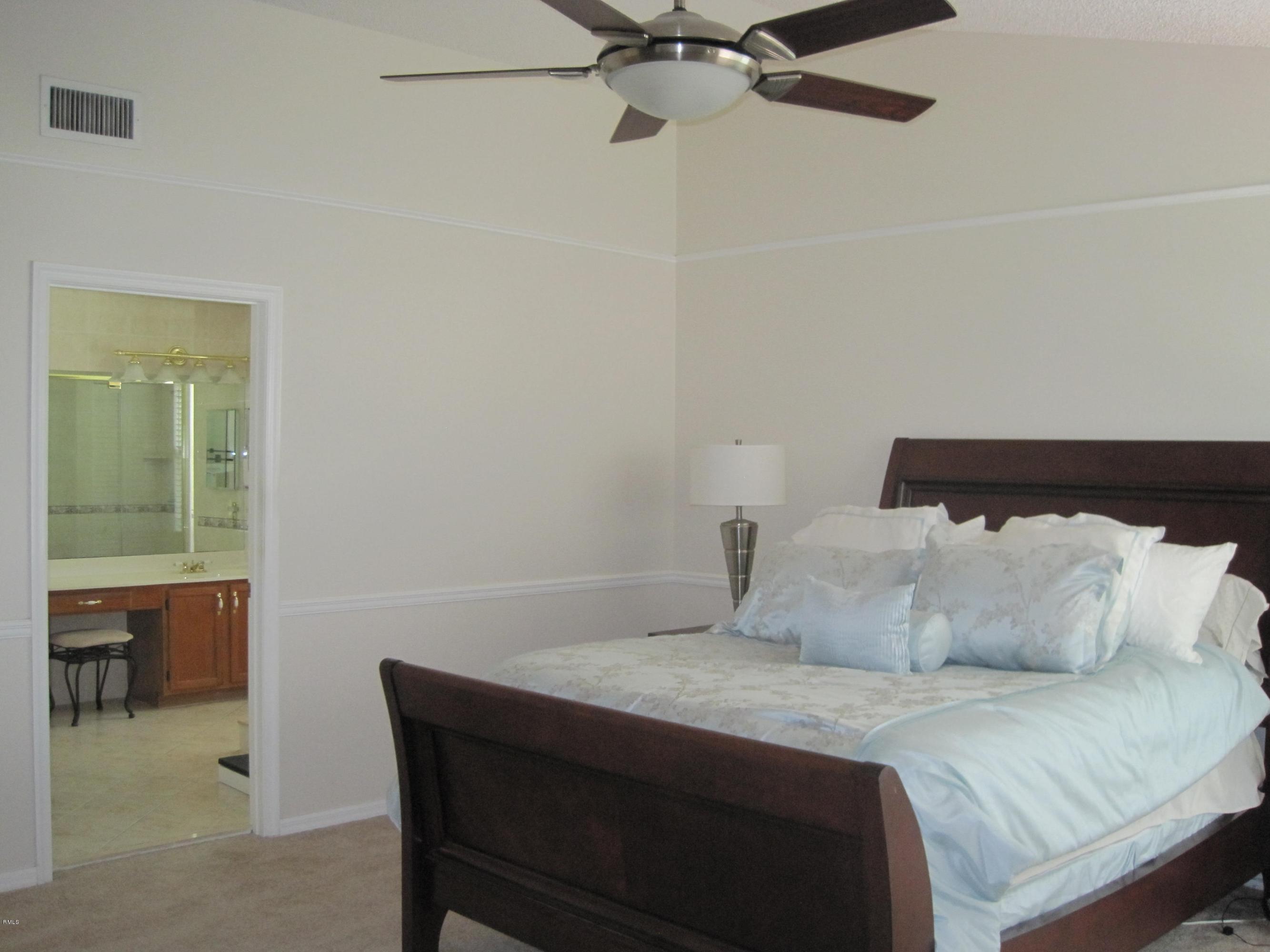 3930 Sabal Lakes Road Delray Beach, FL 33445 - Photo 19 of 30 a bedroom with a bed and a window