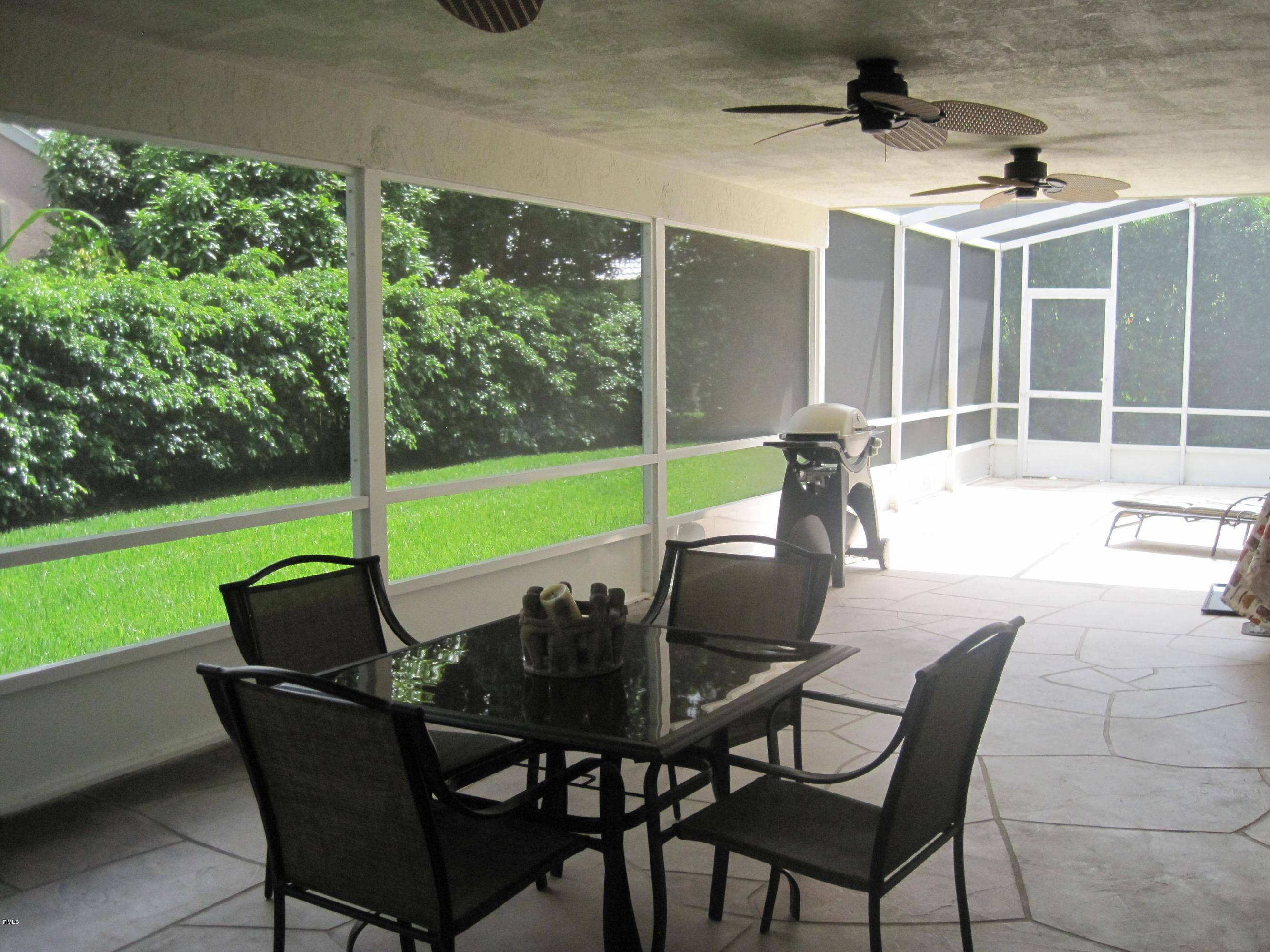 3930 Sabal Lakes Road Delray Beach, FL 33445 - Photo 24 of 30 a view of an outdoor dining space with a table and chairs