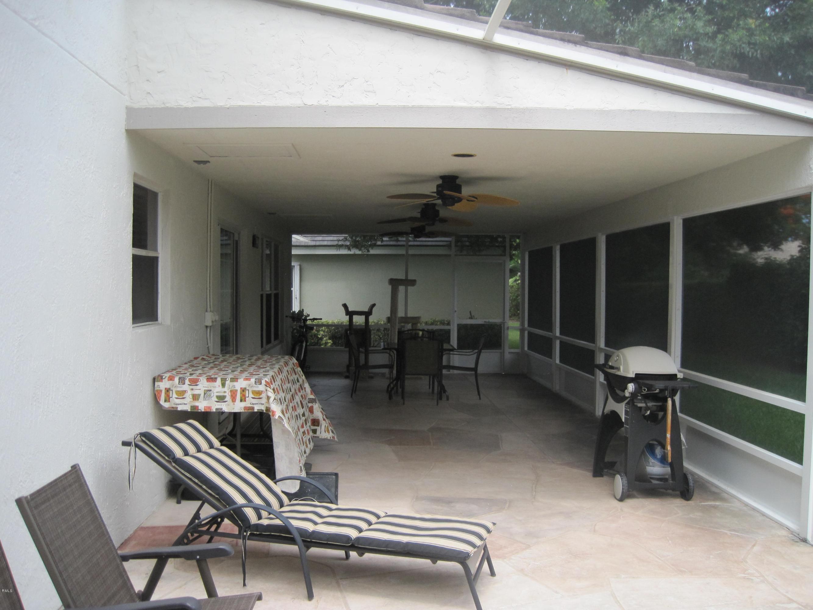3930 Sabal Lakes Road Delray Beach, FL 33445 - Photo 28 of 30 a livingroom with furniture and windows