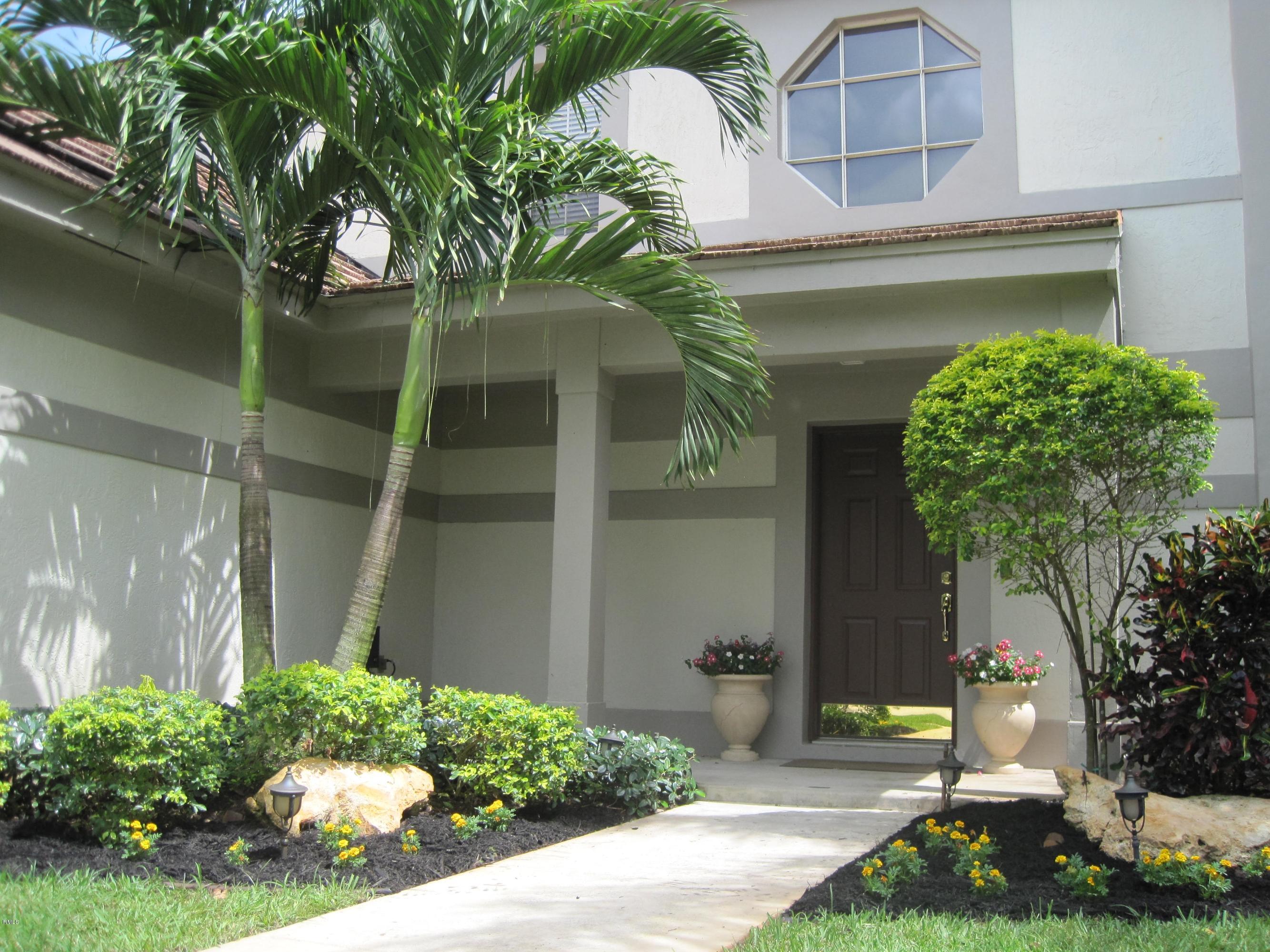 3930 Sabal Lakes Road Delray Beach, FL 33445 - Photo 30 of 30 a front view of a house with garden