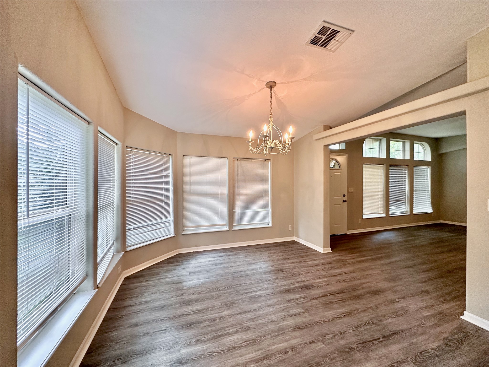 202 Main Street Fresno, TX 77545 - Photo 11 of 26 a view of an empty room with wooden floor and a window